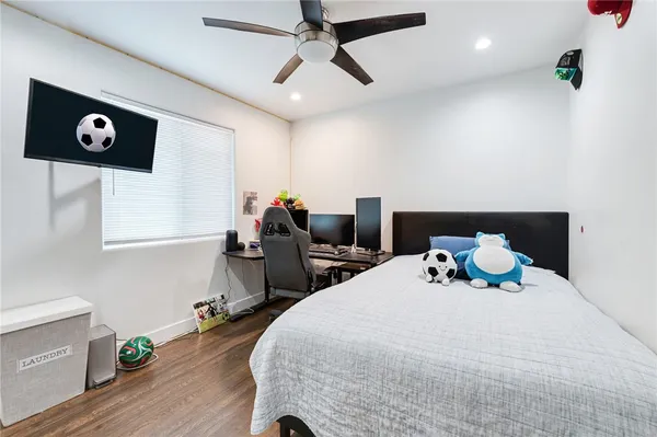 a bedroom with bed and wooden floor