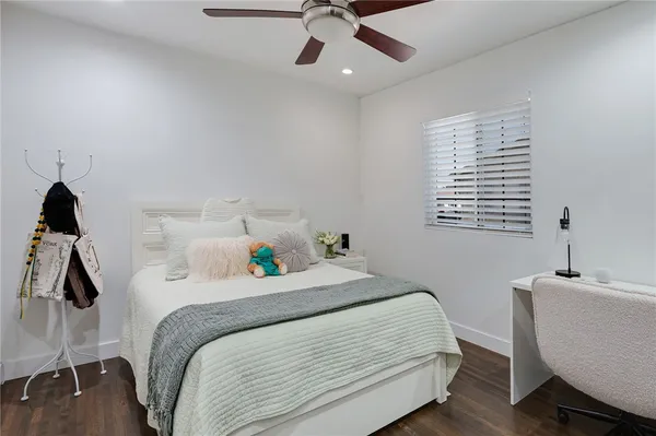 a bedroom with a bed and a desk
