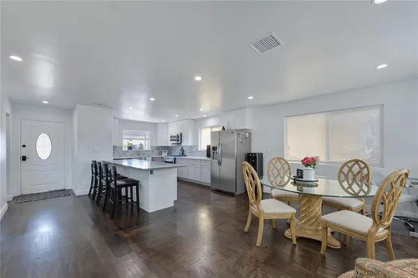a view of a dining room with furniture and wooden floor