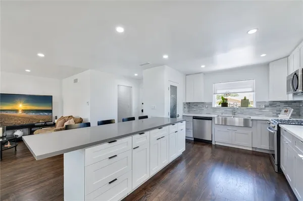 a kitchen with counter top space sink and refrigerator