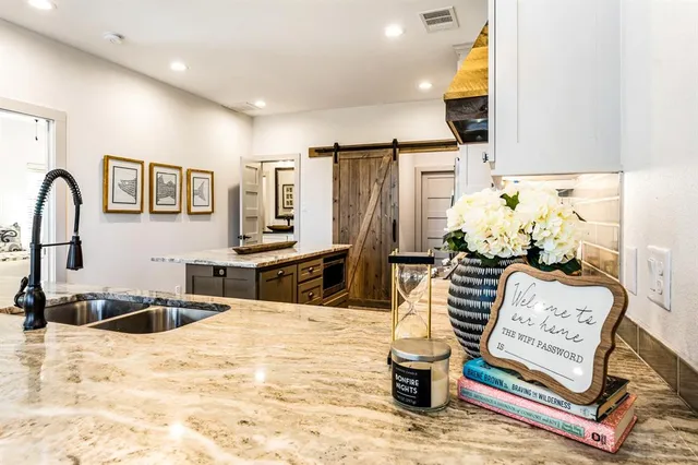 a kitchen with stainless steel appliances kitchen island granite countertop a sink and cabinets