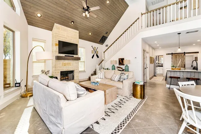 a living room with furniture a fireplace and a flat screen tv