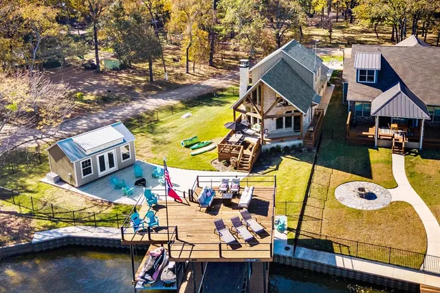 an aerial view of a house with swimming pool and patio