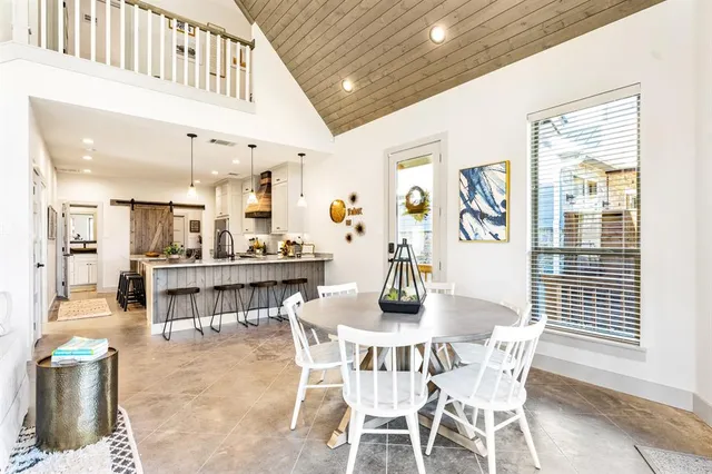 a dining room with furniture and a floor to ceiling window