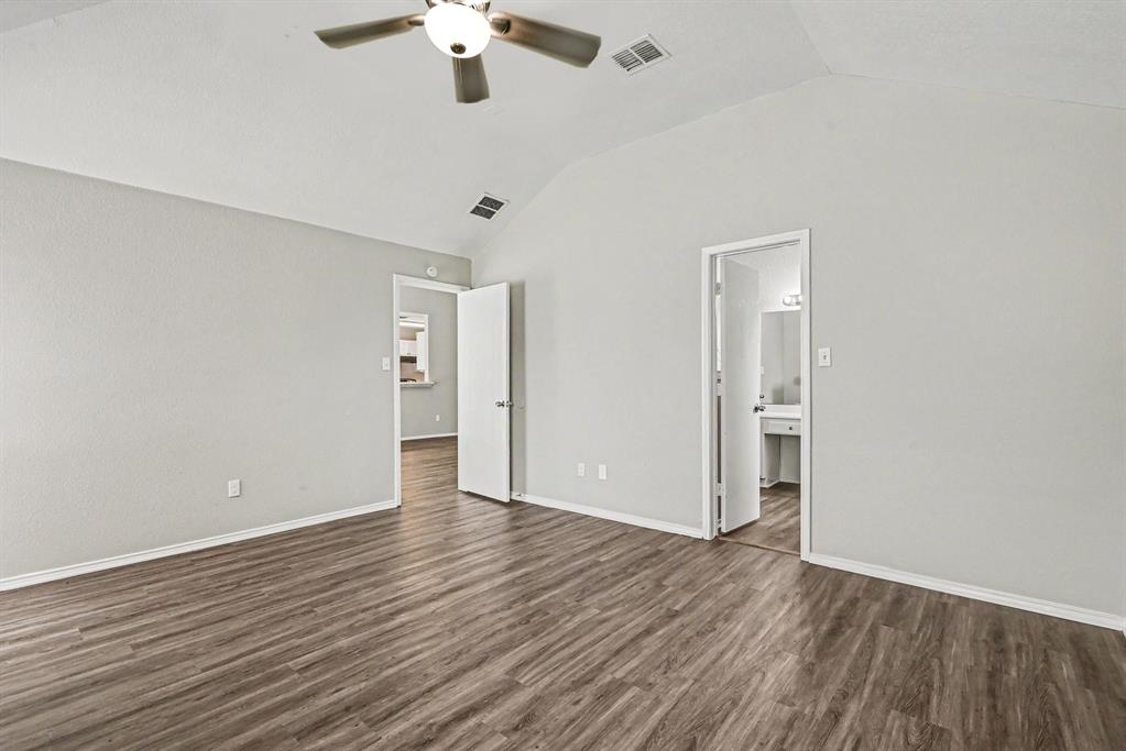 138 Kings Way Drive Rhome, TX 76078 - Photo 7 of 16 an empty room with wooden floor chandelier fan and windows