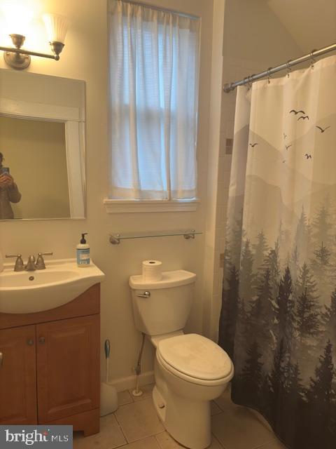 331 Rossiter Avenue Baltimore, MD 21212 - Photo 12 of 28 a bathroom with a toilet sink and mirror