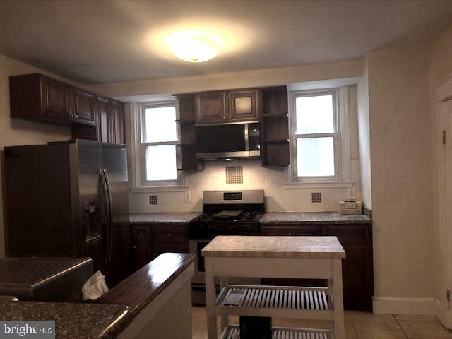 331 Rossiter Avenue Baltimore, MD 21212 - Photo 3 of 28 a kitchen with a sink and a refrigerator