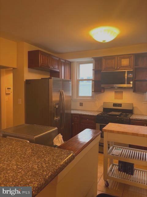331 Rossiter Avenue Baltimore, MD 21212 - Photo 5 of 28 a kitchen that has a sink and a stove