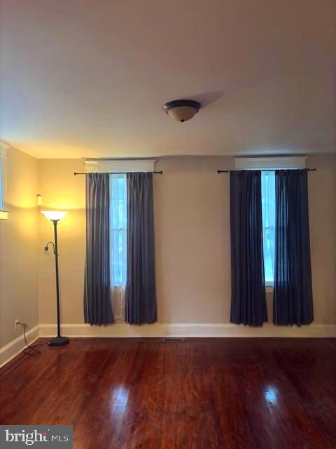 331 Rossiter Avenue Baltimore, MD 21212 - Photo 9 of 28 an empty room with wooden floor and windows