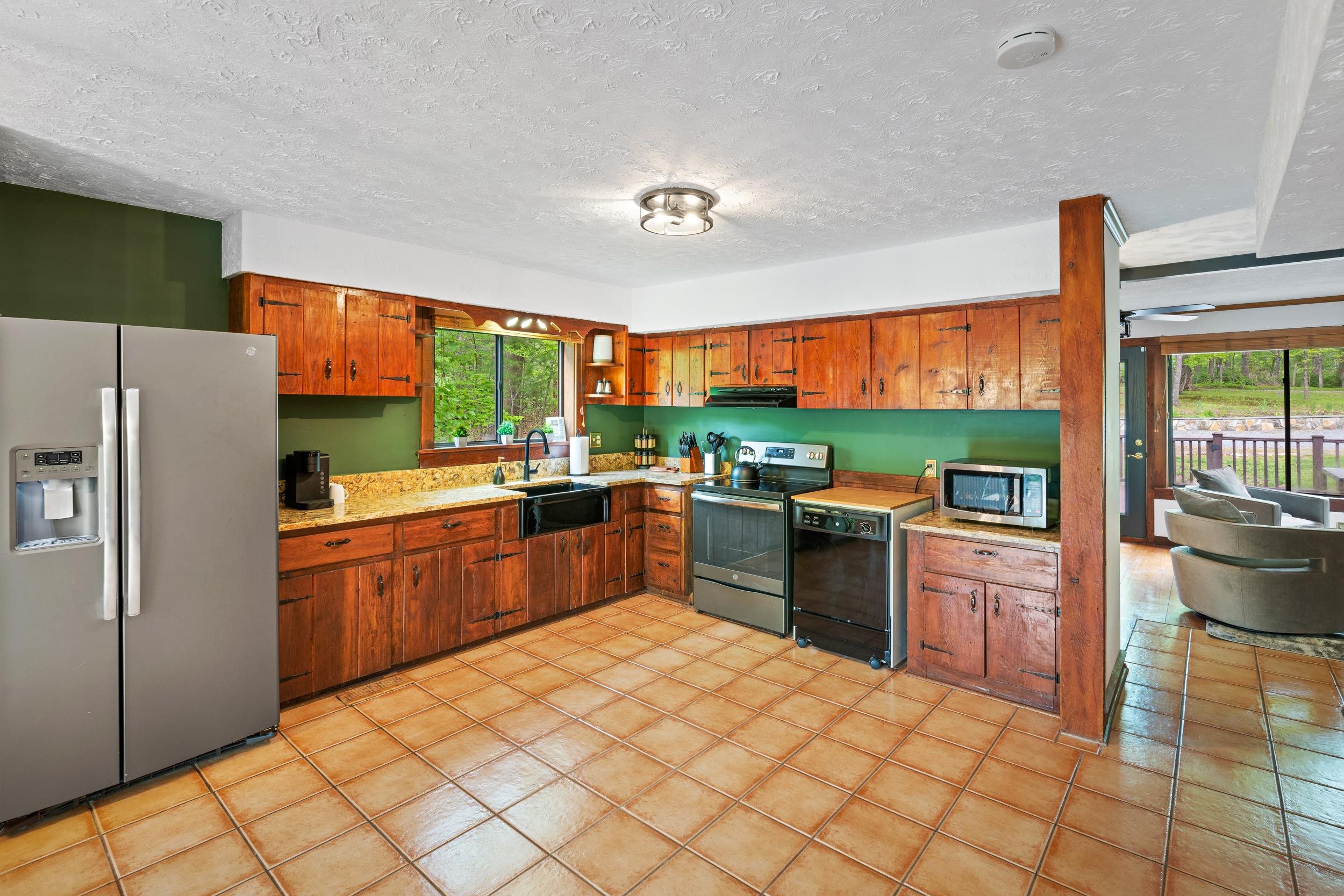 307 CC Road Madison, VA 22727 - Photo 16 of 26 a kitchen with stainless steel appliances kitchen island granite countertop a refrigerator a sink dishwasher a oven with a dining table and chairs