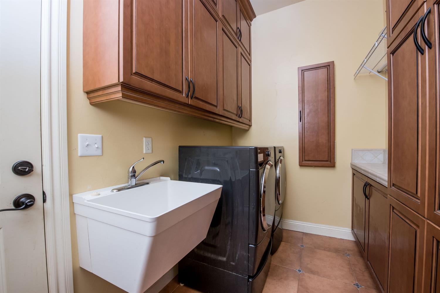 50070 Butterfield Stage Road O'Neals, CA 93645 - Photo 30 of 55 This laundry room has lots of custom cabinets and even a built in ironing board....