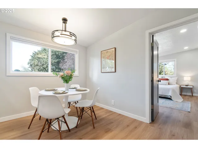 a view of a dining room with furniture wooden floor and a chandelier