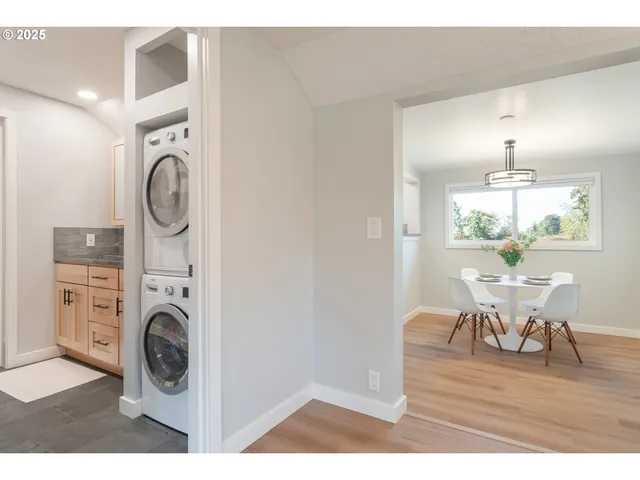 a view of a kitchen area with furniture and wooden floor