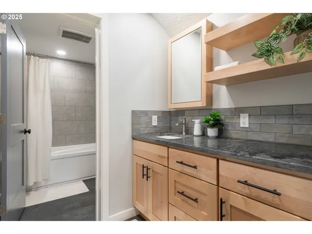 a bathroom with a sink and a mirror