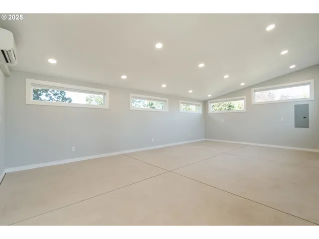 a view of an empty room with windows
