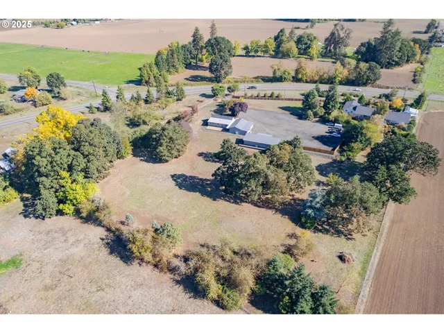 an aerial view of a house with a yard and lake view