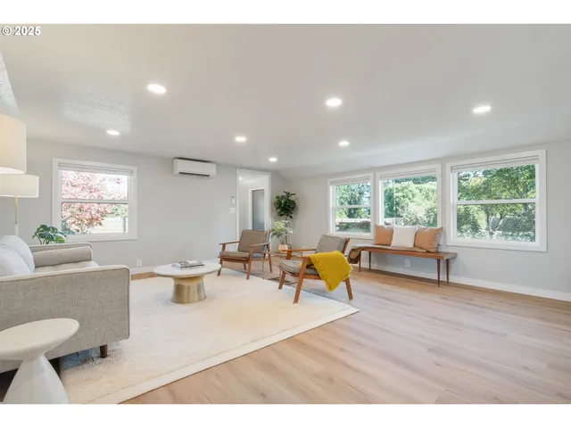 a living room with furniture a window and a table