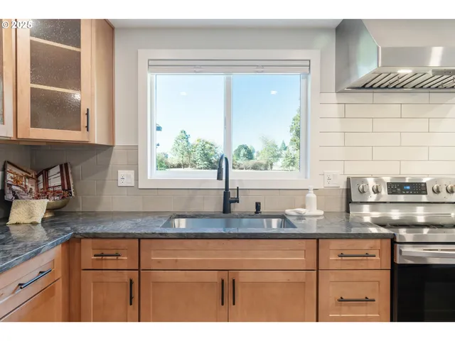 a kitchen with granite countertop a sink and a window