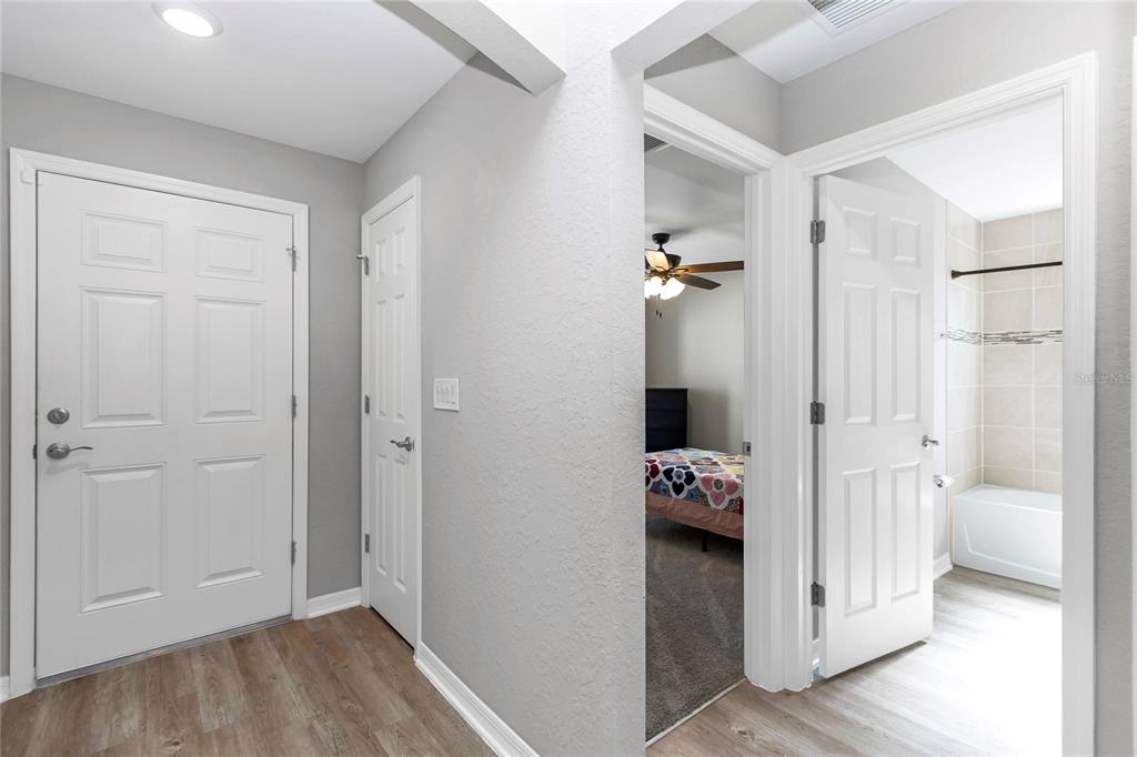 Undisclosed Address Ocala, FL 34480 - Photo 12 of 38 a view of a hallway with bathroom and wooden floor