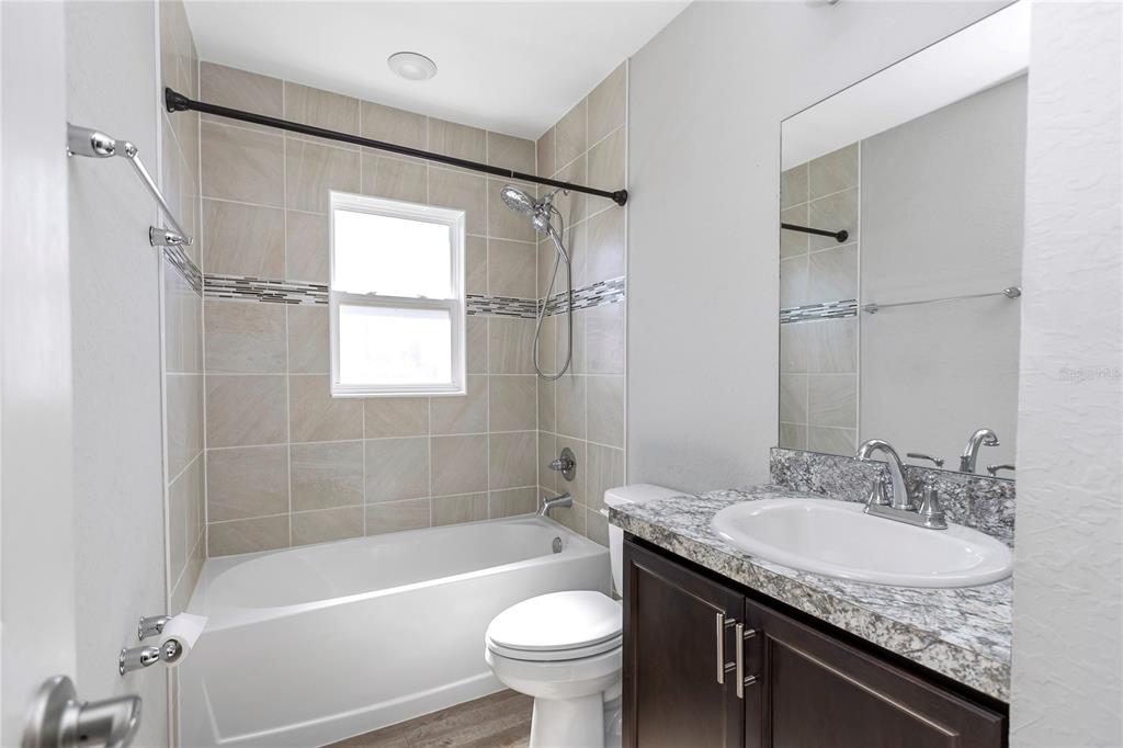 Undisclosed Address Ocala, FL 34480 - Photo 16 of 38 a bathroom with a granite countertop sink toilet and shower