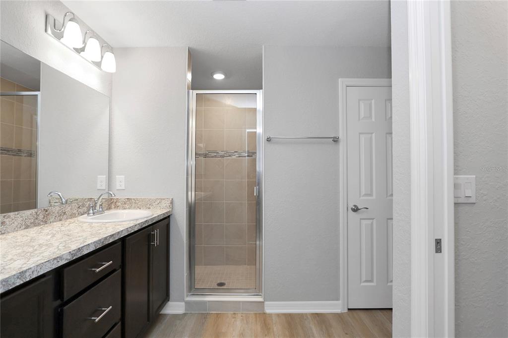 Undisclosed Address Ocala, FL 34480 - Photo 24 of 38 a bathroom with a granite countertop sink two mirror and shower