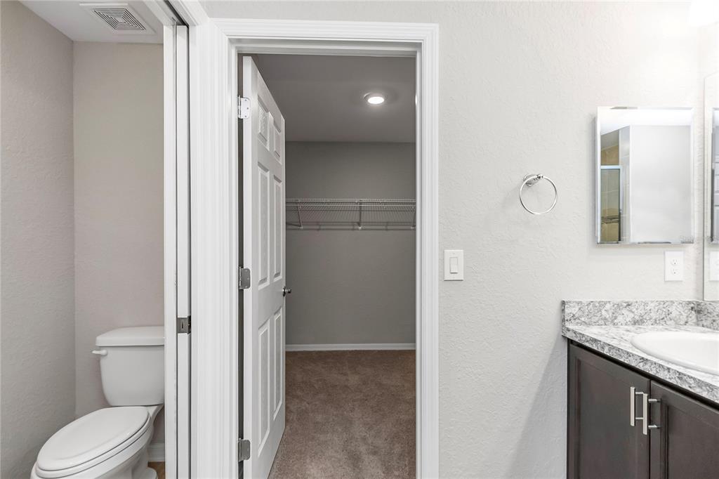 Undisclosed Address Ocala, FL 34480 - Photo 25 of 38 a en suite bathroom with a granite countertop sink and a mirror