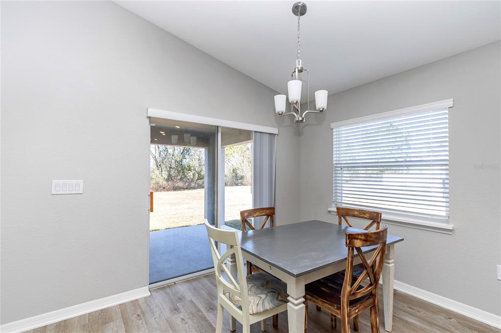 Undisclosed Address Ocala, FL 34480 - Photo 28 of 38 a view of a dining room with furniture wooden floor and chandelier