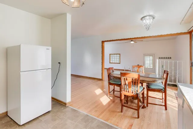 a dining room with furniture and a refrigerator