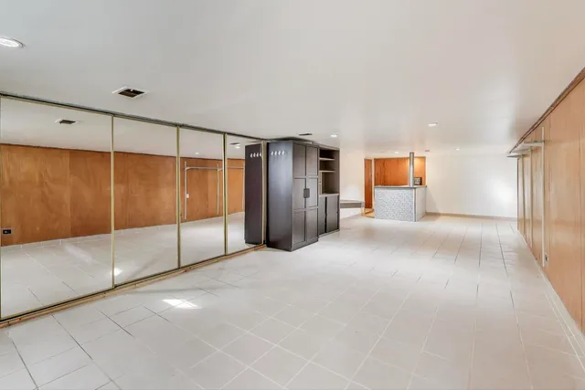 a view of an empty room with glass door