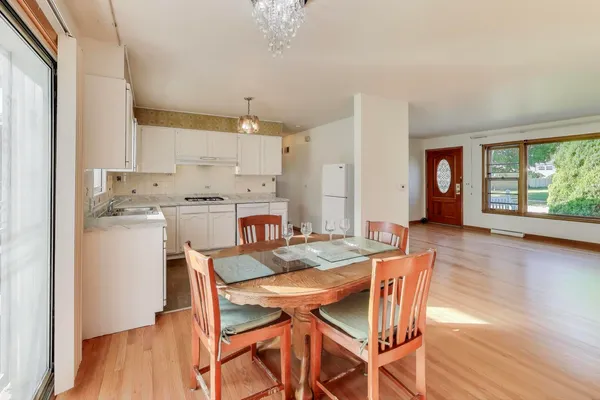 a view of a dining room with furniture and wooden floor