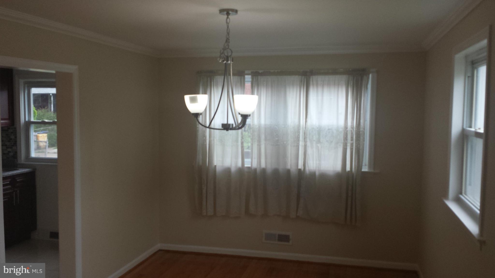 1560 Clairidge Road Baltimore, MD 21207 - Photo 11 of 16 a view of empty room with wooden floor and fan