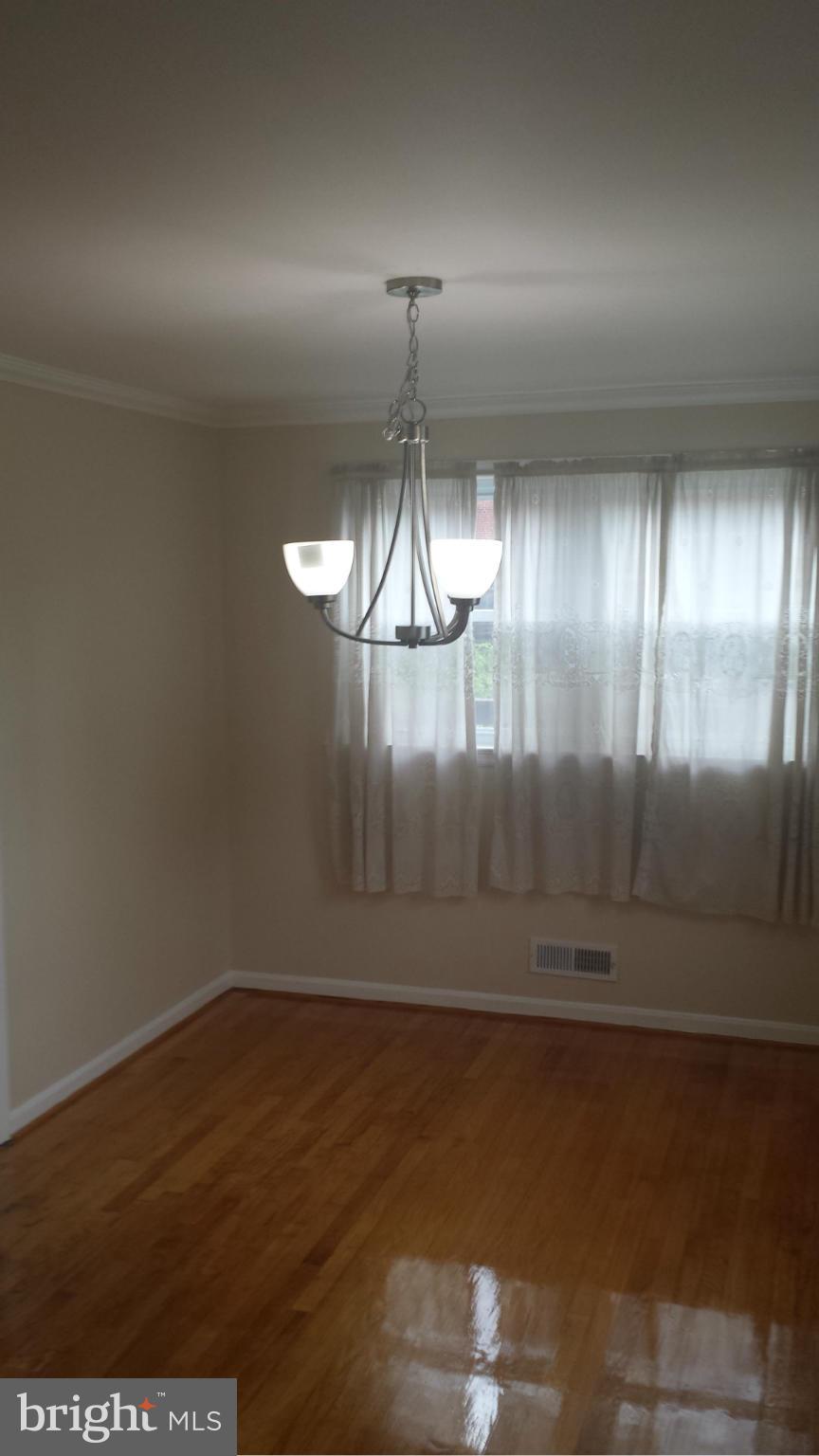 1560 Clairidge Road Baltimore, MD 21207 - Photo 12 of 16 a view of empty room with wooden floor