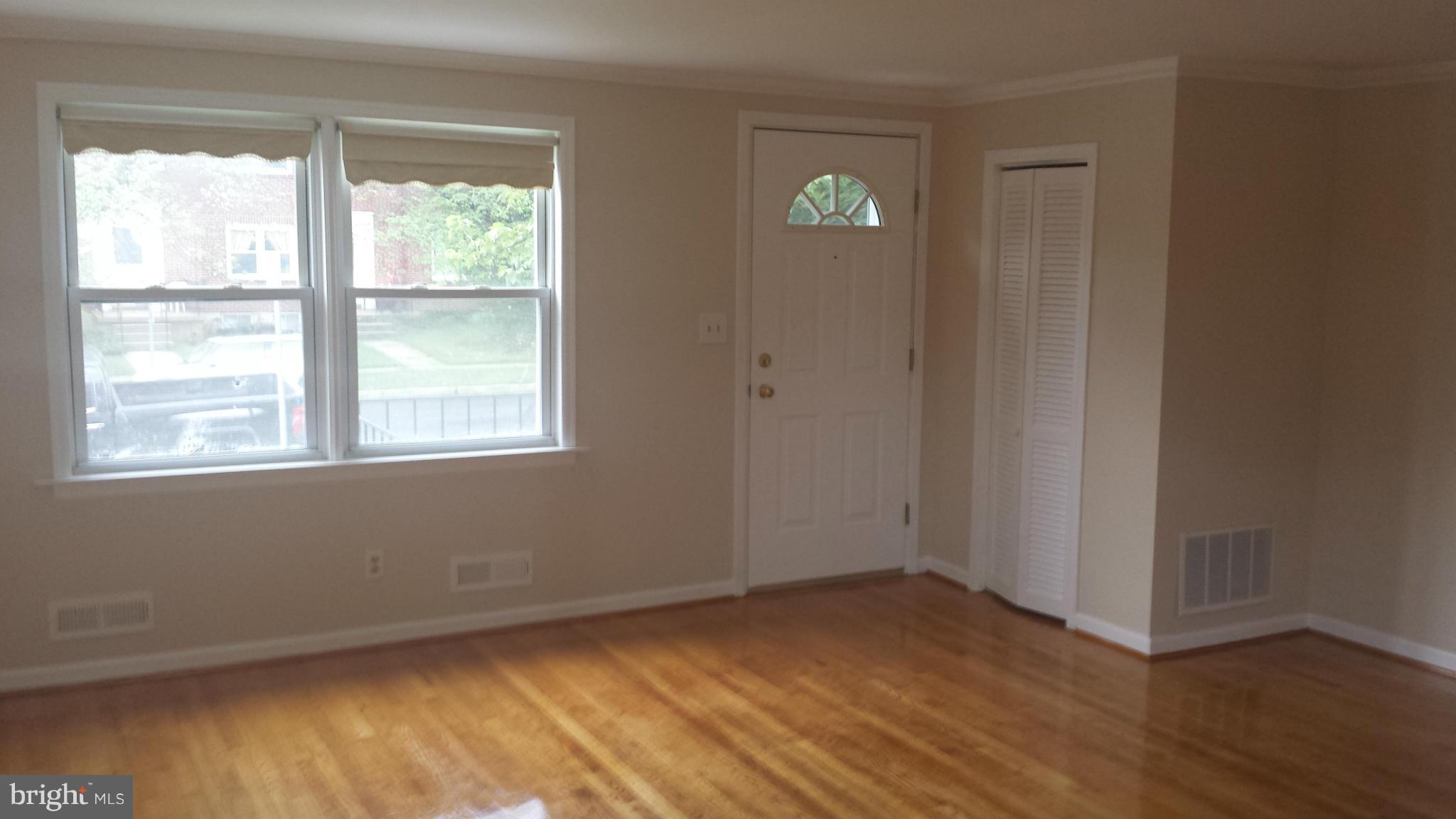 1560 Clairidge Road Baltimore, MD 21207 - Photo 13 of 16 a view of an empty room with wooden floor and a window