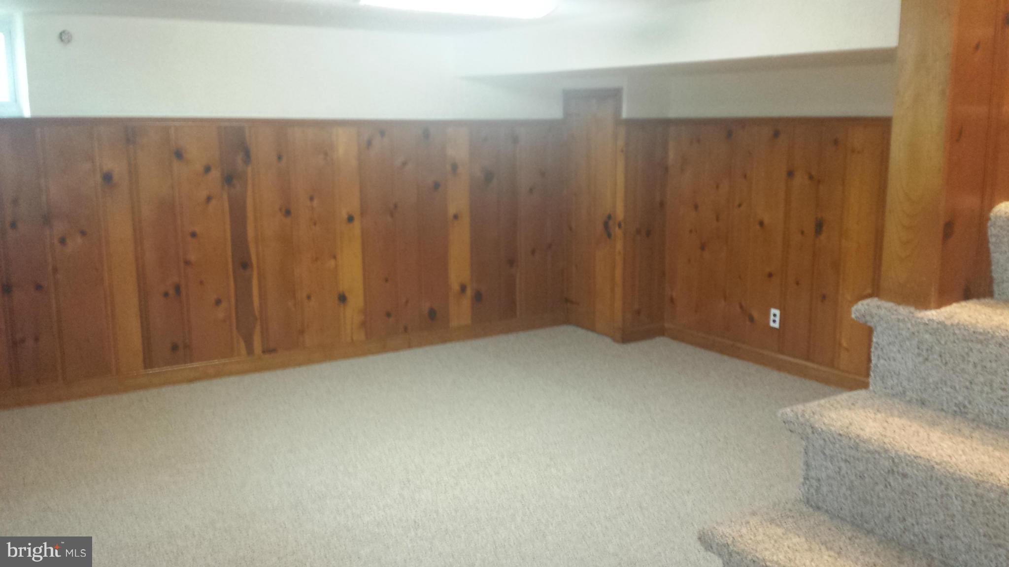 1560 Clairidge Road Baltimore, MD 21207 - Photo 3 of 16 a view of an empty room and wooden walls