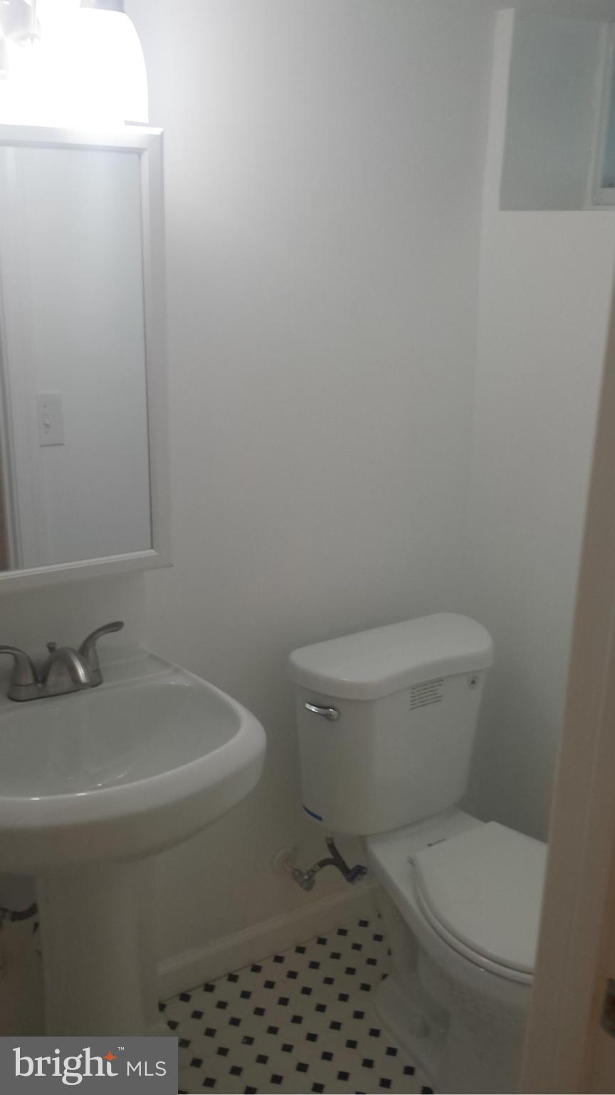 1560 Clairidge Road Baltimore, MD 21207 - Photo 5 of 16 a white toilet sitting next to a bathroom sink