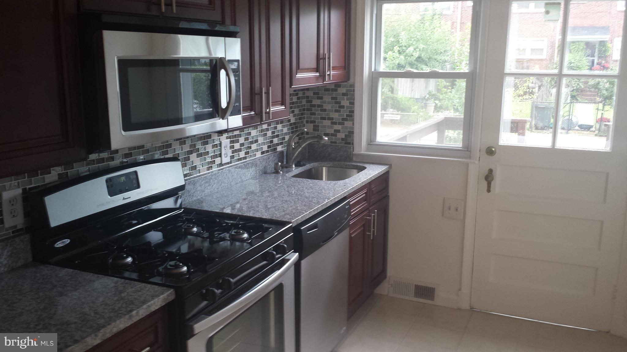 1560 Clairidge Road Baltimore, MD 21207 - Photo 10 of 16 a kitchen with a stove and a sink