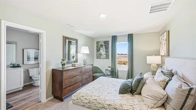 a bedroom with furniture and a lamp