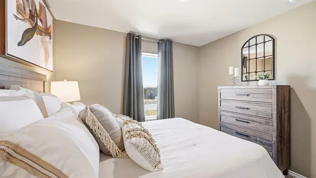 a bedroom with a bed and a painting on the wall