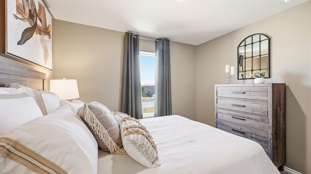 5424 Corduroy Road Krum, TX 76249 - Photo 21 of 38 a bedroom with a bed and a mirror on dresser