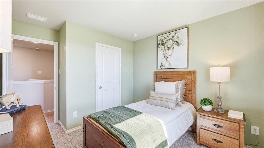 5424 Corduroy Road Krum, TX 76249 - Photo 22 of 38 a bedroom with a bed and a lamp on dresser