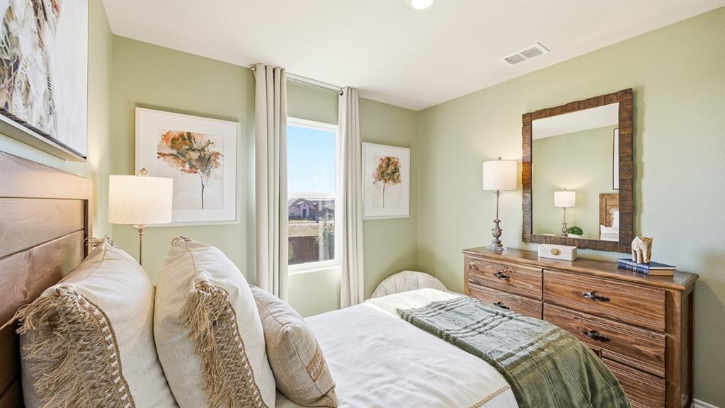 5424 Corduroy Road Krum, TX 76249 - Photo 24 of 38 a bedroom with a bed and dresser with mirror
