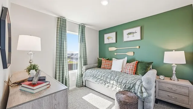 a bedroom with a bed and painting on the wall