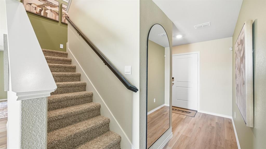 5424 Corduroy Road Krum, TX 76249 - Photo 33 of 38 a view of entryway and hall with wooden floor