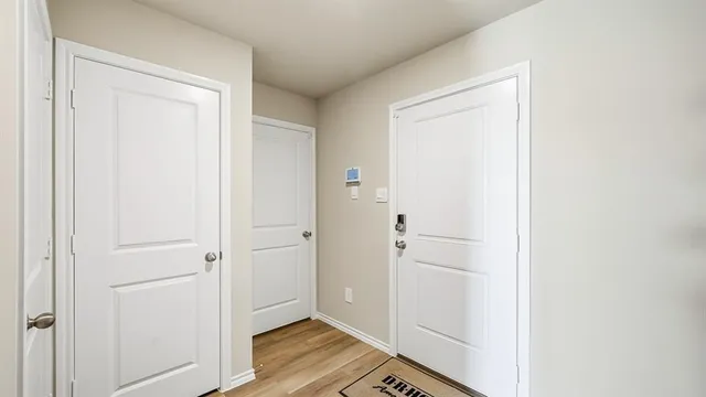 a view of entryway and hall with wooden floor
