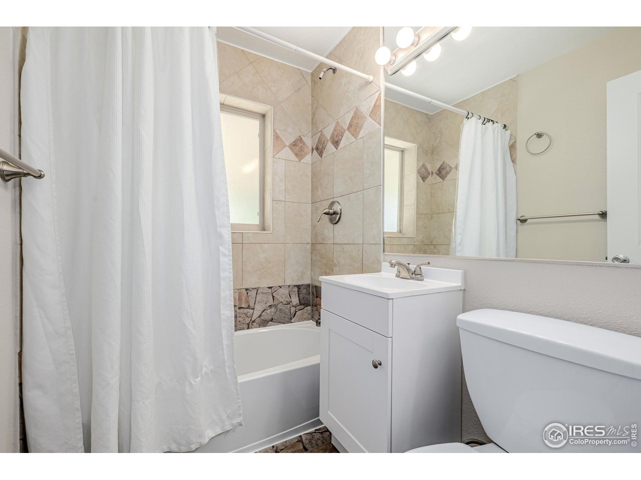 2675 Pontiac Street Denver, CO 80207 - Photo 14 of 50 a bathroom with a sink a toilet and shower