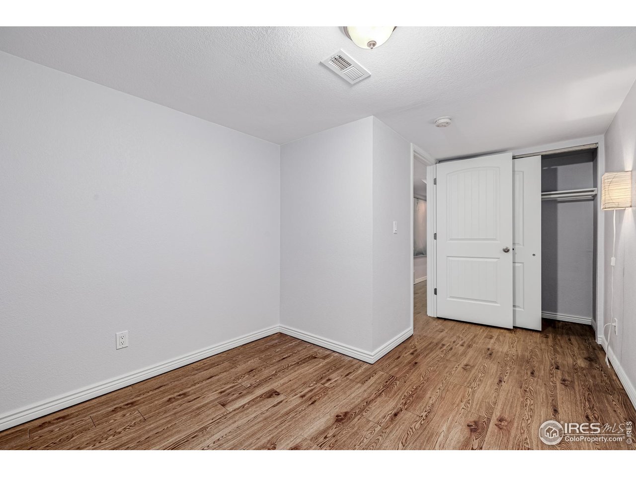 2675 Pontiac Street Denver, CO 80207 - Photo 19 of 50 a view of an empty room with wooden floor