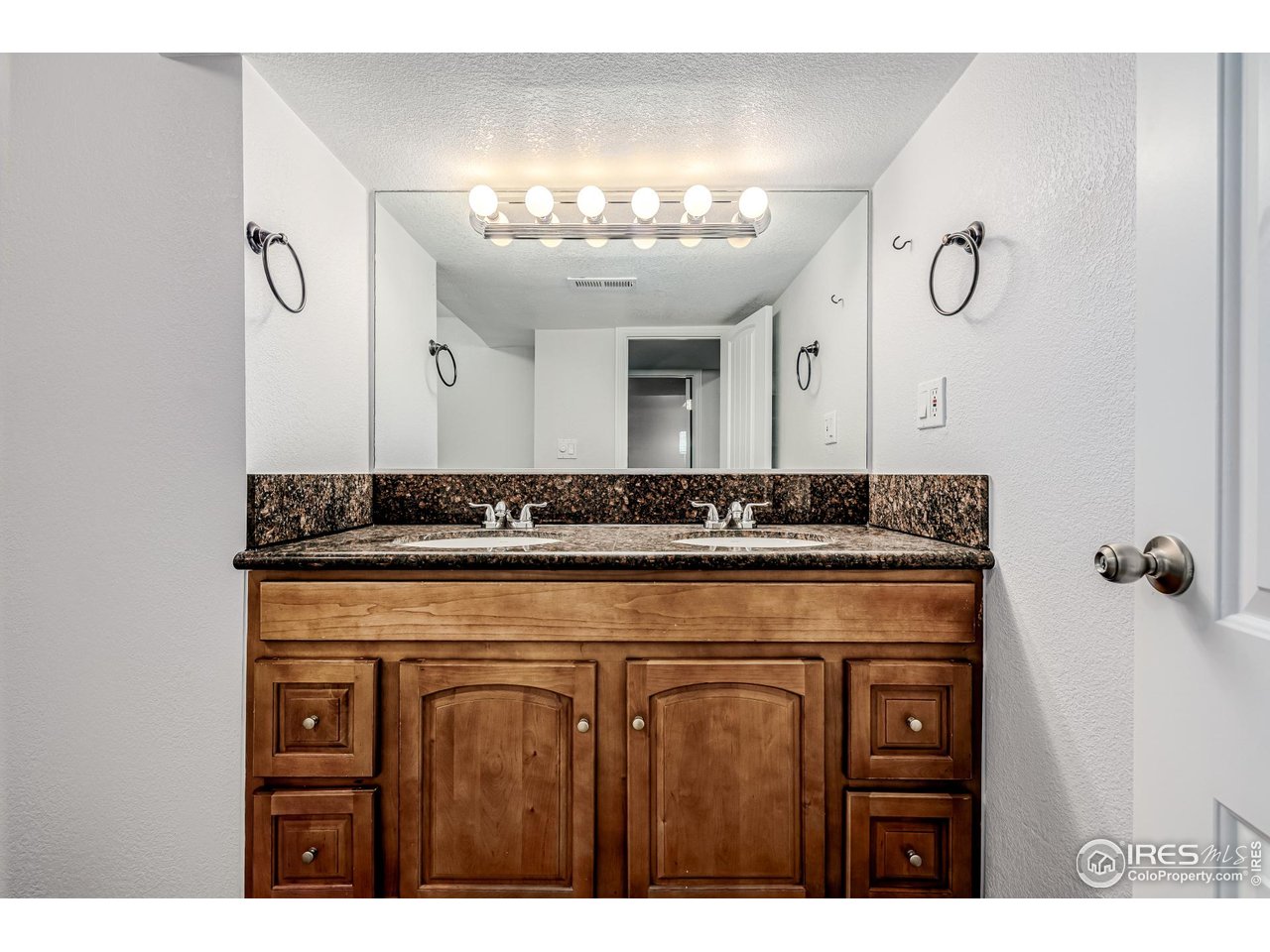 2675 Pontiac Street Denver, CO 80207 - Photo 23 of 50 a bathroom with a sink and a mirror
