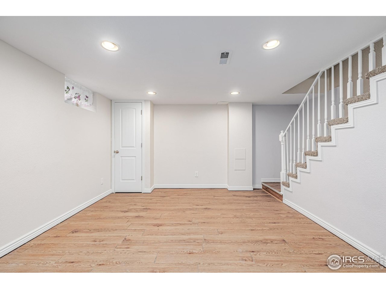 2675 Pontiac Street Denver, CO 80207 - Photo 32 of 50 a view of an empty room with wooden floor