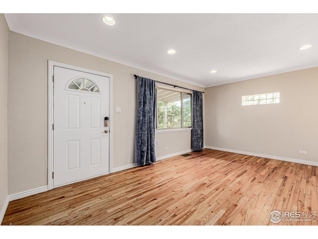 2675 Pontiac Street Denver, CO 80207 - Photo 5 of 50 a view of an empty room with wooden floor and a window