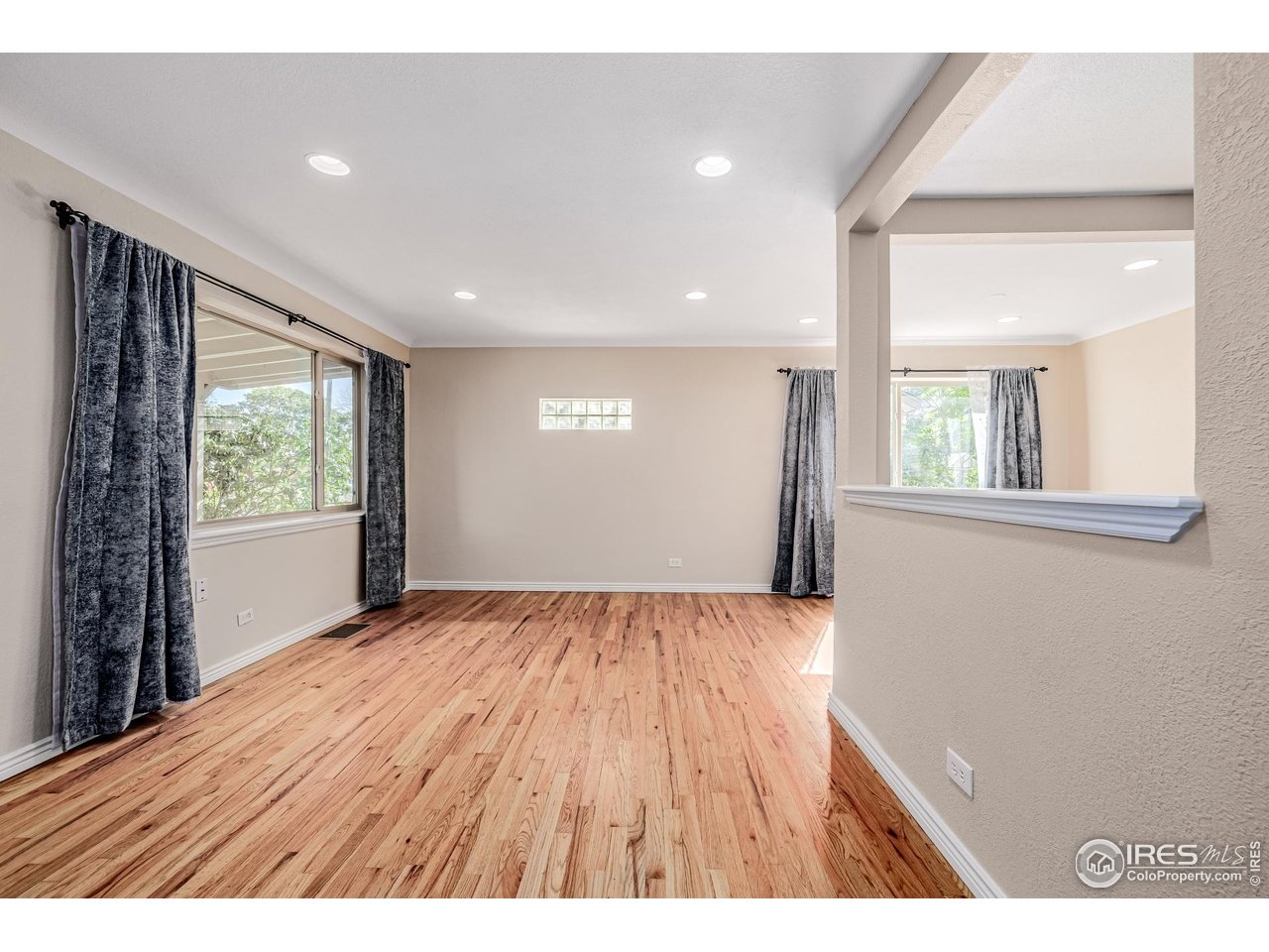 2675 Pontiac Street Denver, CO 80207 - Photo 6 of 50 a view of an empty room with wooden floor and a window